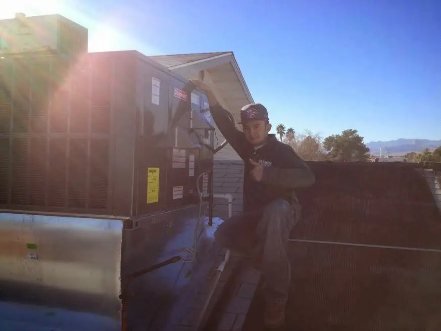 HVAC technician performing HVAC Inspection on a rooftop unit in San Francisco